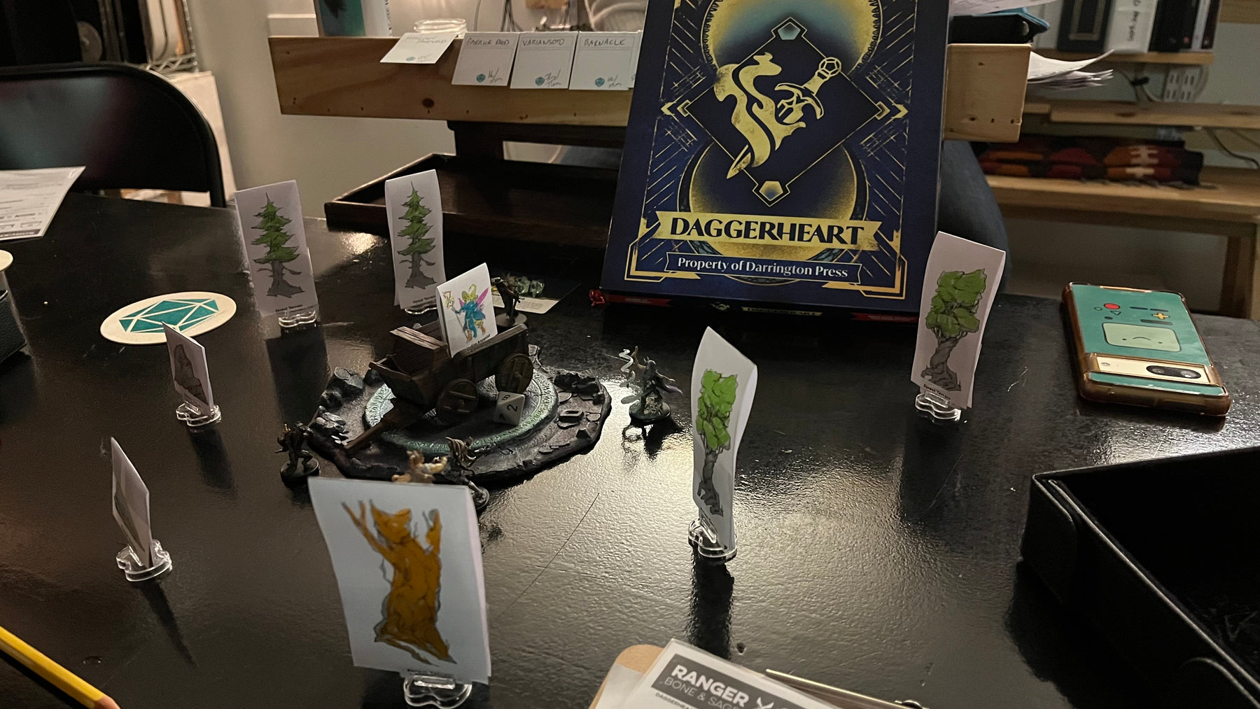 Daggerheart box and standees at the table