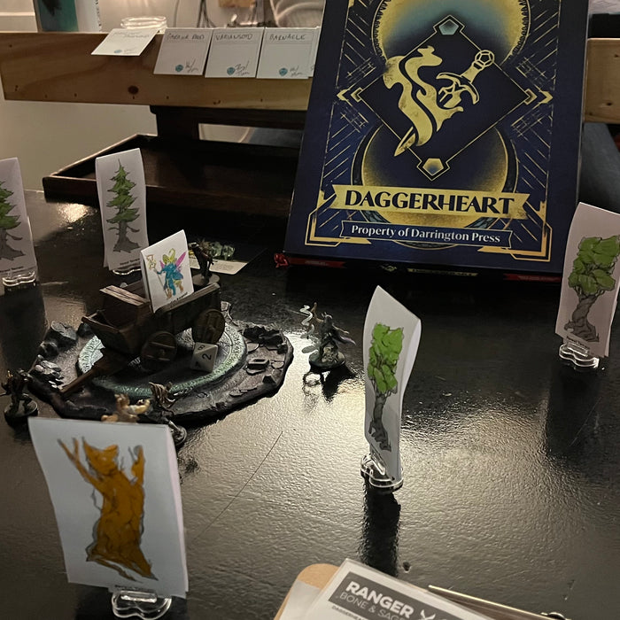 Daggerheart box and standees at the table