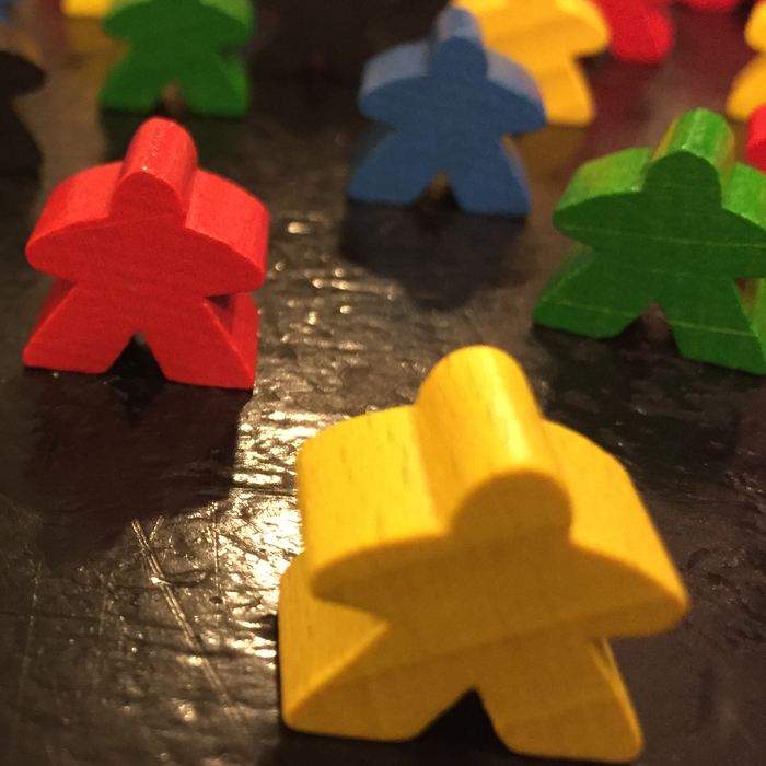 Close up of Meeple game pieces