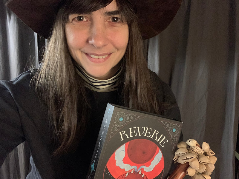 Lauren Bilanko holding a Reverie Deck on a dark witchy background